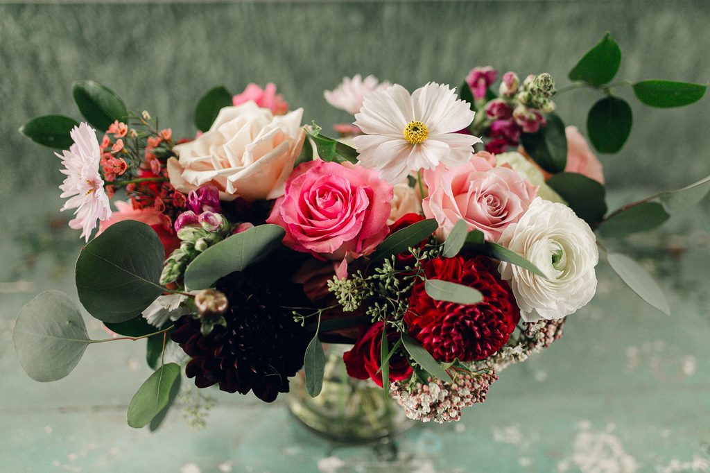 Bridal bouquet of blush, bright pink, ivory, and burgundy flowers with loose greenery for her Dresser Mansion Wedding.