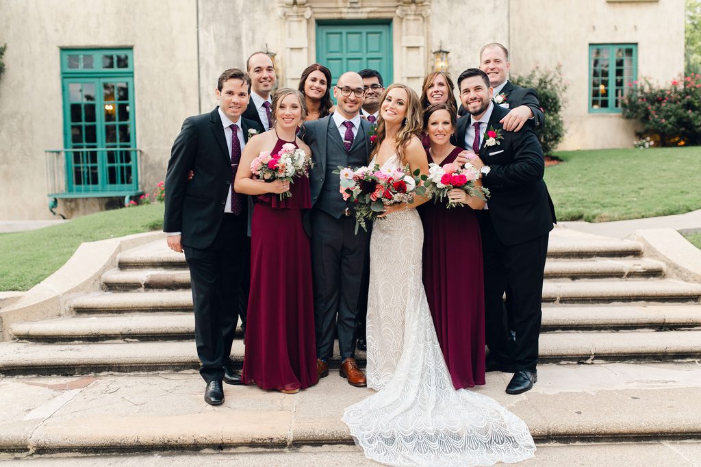 Megan and Keivan posing with their wedding party on the front steps of Dresser Mansion. 